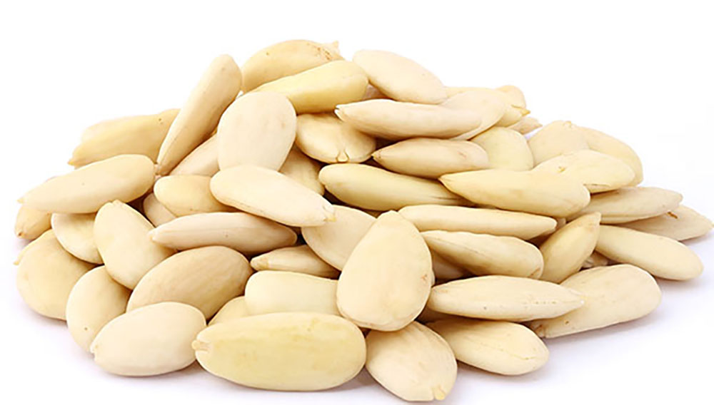 Peeled almonds on white background